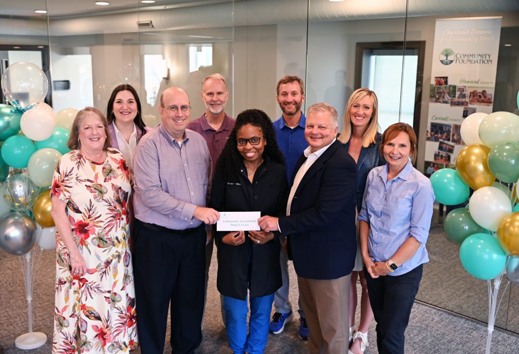 Andy Zirkle, Grants and Contracts Manager at IHC, and Dr. Jerra Sharp, DMD, Deputy Chief Dental Officer, pose with the Community Foundation of Howard County upon receiving the grant award.